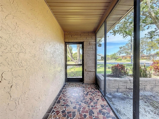 unfurnished sunroom featuring wood ceiling