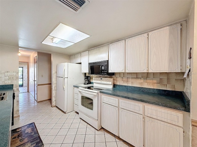 kitchen with decorative backsplash, light tile patterned floors, and white appliances