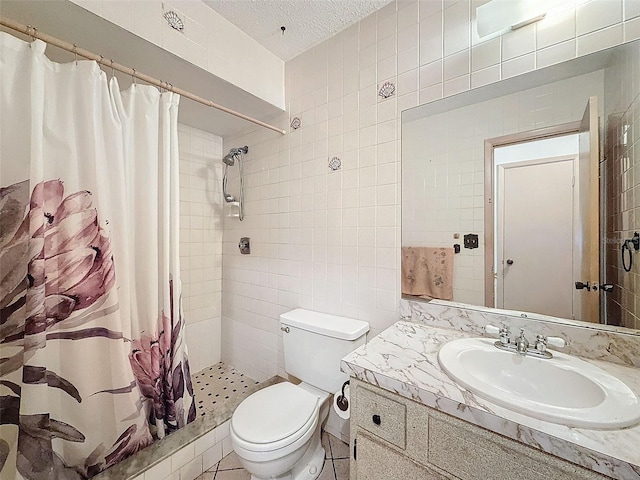 bathroom featuring a textured ceiling, toilet, tile walls, a shower with curtain, and vanity