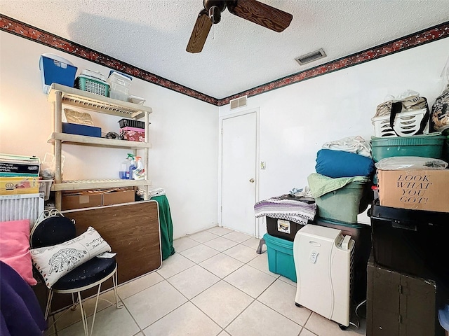 interior space featuring ceiling fan and a textured ceiling