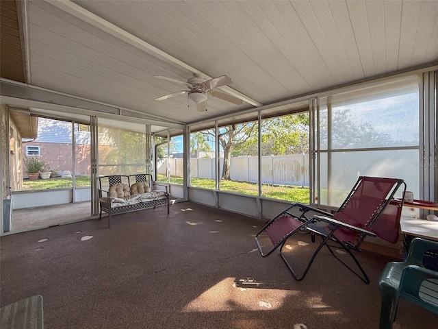 unfurnished sunroom with ceiling fan