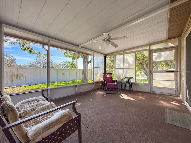 sunroom featuring a healthy amount of sunlight, wooden ceiling, and vaulted ceiling