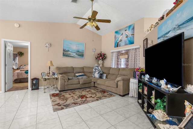 tiled living room with ceiling fan and vaulted ceiling