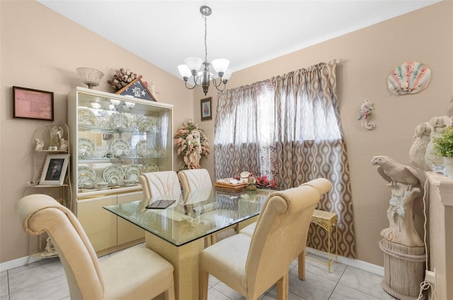 tiled dining space with an inviting chandelier