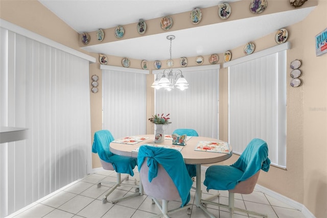 tiled dining space featuring a chandelier