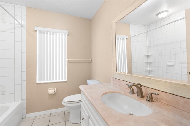 full bathroom with a textured ceiling, toilet, tile patterned floors, tiled shower / bath, and vanity