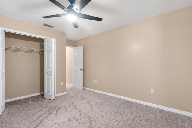 unfurnished bedroom featuring a closet, ceiling fan, and light carpet