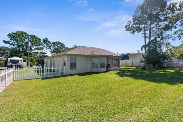 rear view of house with a lawn