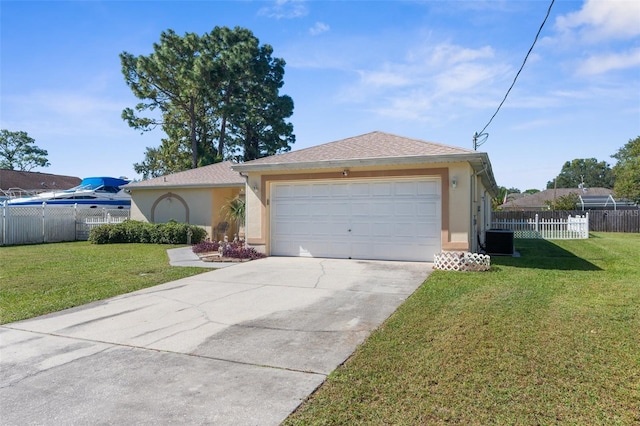 view of front of house with a front yard, a garage, and central AC unit