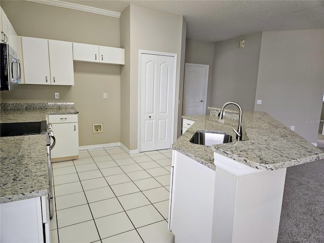 kitchen featuring light stone countertops, a textured ceiling, white cabinetry, and sink