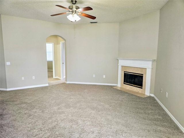 unfurnished living room featuring carpet, a textured ceiling, and ceiling fan