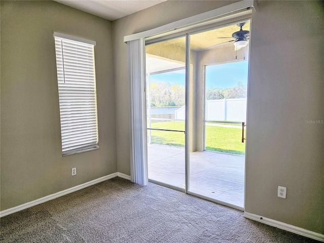 entryway with ceiling fan and carpet floors