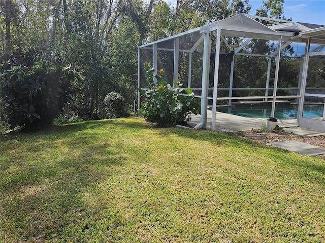 view of yard with glass enclosure