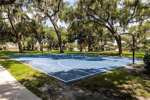 view of basketball court with a yard