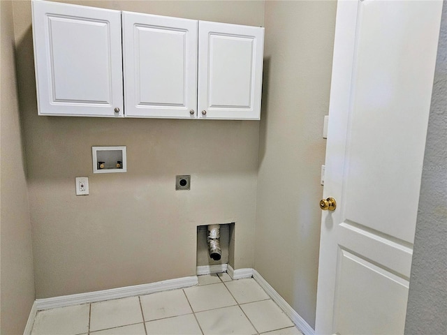 washroom with hookup for an electric dryer, light tile patterned flooring, cabinets, and hookup for a washing machine