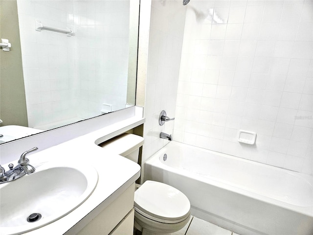 full bathroom with vanity, tiled shower / bath combo, and toilet