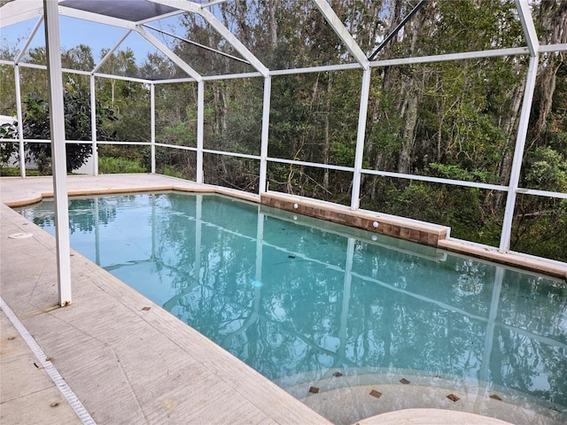 view of swimming pool with a lanai