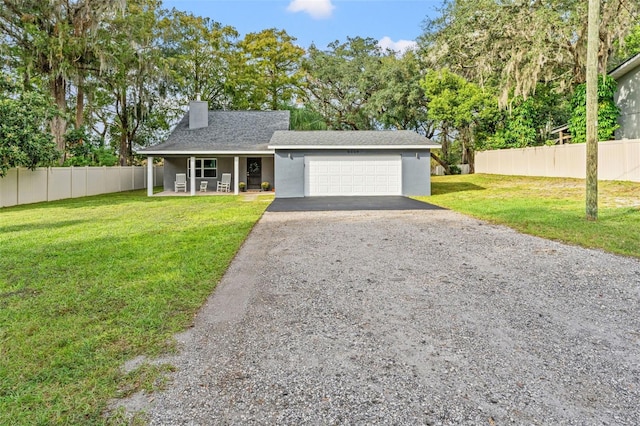 view of front of home featuring a garage and a front lawn