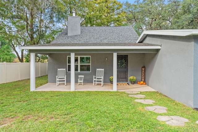 rear view of property with a lawn