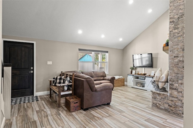 living room with high vaulted ceiling and light wood-type flooring