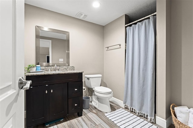 bathroom featuring vanity, toilet, a shower with curtain, and hardwood / wood-style floors