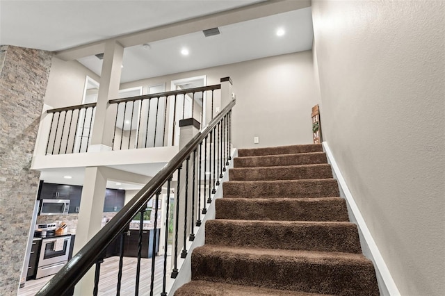 stairs featuring wood-type flooring