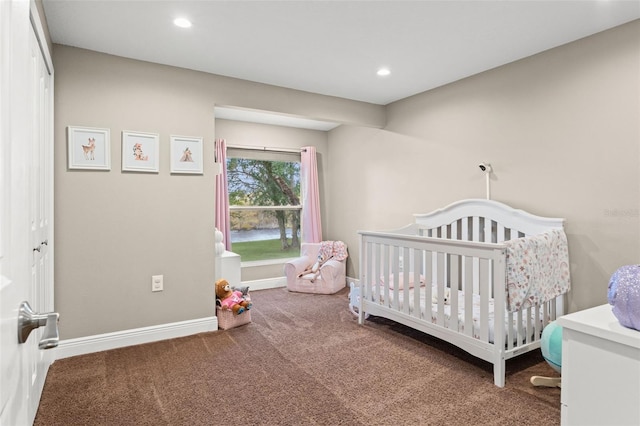 carpeted bedroom with a closet and a crib