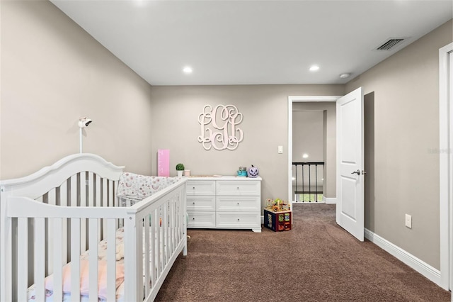 bedroom with dark carpet and a nursery area