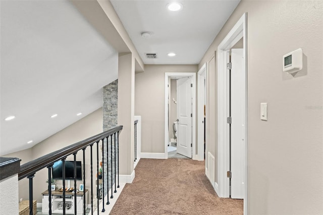 hallway with light colored carpet