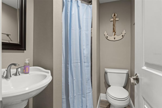 bathroom featuring sink and toilet