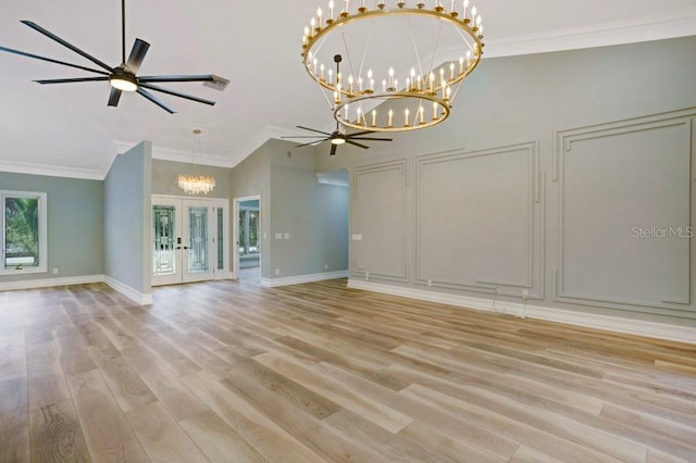 unfurnished living room featuring french doors, light hardwood / wood-style floors, ceiling fan, and crown molding