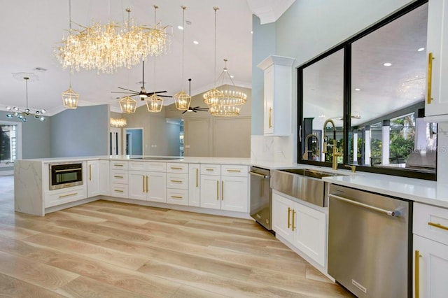 kitchen featuring white cabinets, stainless steel appliances, light hardwood / wood-style floors, and decorative light fixtures