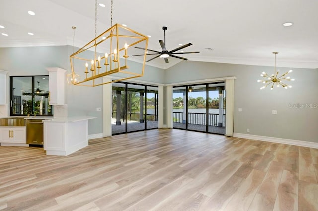 unfurnished living room with ceiling fan with notable chandelier, light wood-type flooring, and lofted ceiling