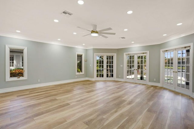 spare room with french doors, light hardwood / wood-style floors, ceiling fan, and crown molding