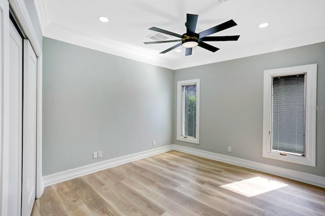 unfurnished bedroom featuring a closet, ceiling fan, light hardwood / wood-style floors, and crown molding