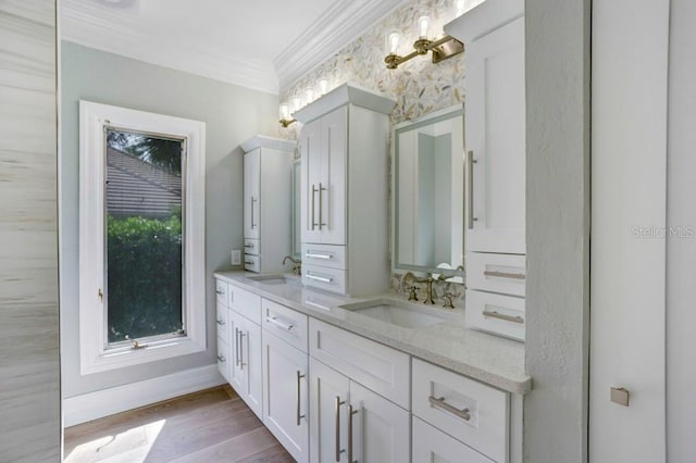 bathroom with vanity, hardwood / wood-style flooring, and crown molding