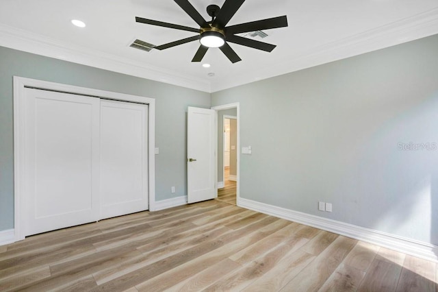 unfurnished bedroom with light hardwood / wood-style flooring, ceiling fan, crown molding, and a closet