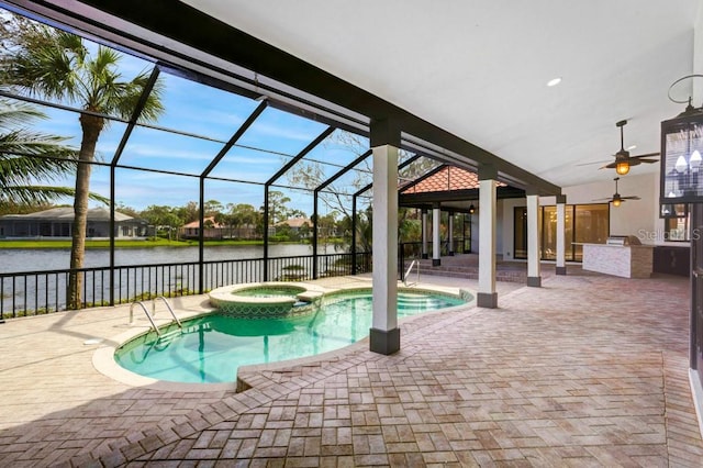 view of swimming pool with an in ground hot tub, a water view, ceiling fan, a patio area, and glass enclosure