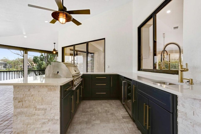 bar featuring a wealth of natural light, light stone countertops, sink, and vaulted ceiling