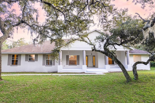 ranch-style home with a yard