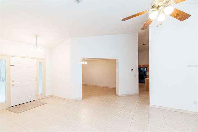 interior space with light tile patterned flooring and ceiling fan with notable chandelier