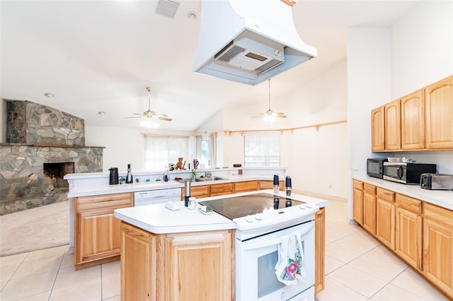 kitchen featuring white appliances, an island with sink, lofted ceiling, light tile patterned floors, and exhaust hood