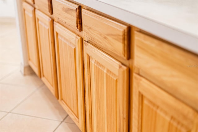 room details featuring light brown cabinets and light tile patterned floors