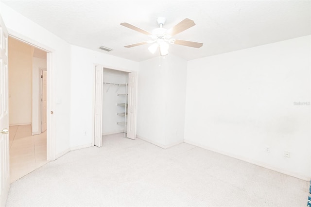 empty room with light colored carpet and ceiling fan