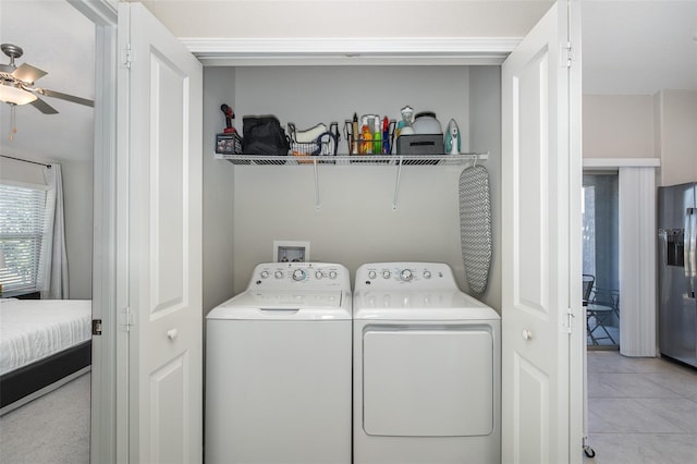 washroom featuring light tile patterned floors, separate washer and dryer, and ceiling fan