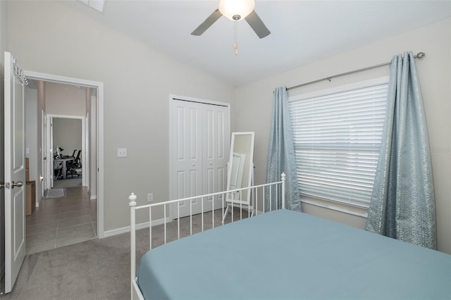 carpeted bedroom with lofted ceiling, a closet, and ceiling fan