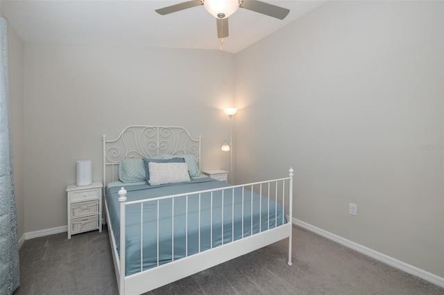 bedroom with vaulted ceiling, dark carpet, and ceiling fan