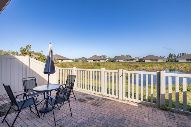 view of patio featuring a water view