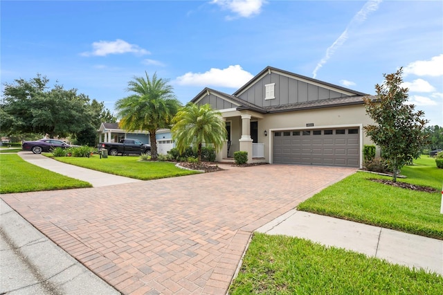 view of front of home featuring a garage and a front lawn