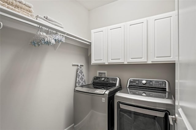 laundry area featuring cabinets and washing machine and clothes dryer